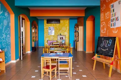 a classroom with tables and chairs in a classroom at JAZ Lamaya Resort in Coraya Bay