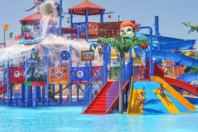 a water park with a water slide in the water at JAZ Makadina in Hurghada