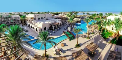 an aerial view of a resort with a pool and palm trees at JAZ Makadina in Hurghada