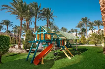 a playground with a house and a slide at JAZ Makadina in Hurghada