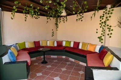 a room with a couch with colorful pillows at Eagles Paradise Abu Soma Resort in Hurghada