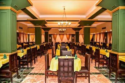 a large banquet hall with tables and chairs at Eagles Paradise Abu Soma Resort in Hurghada