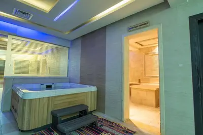 a large bathroom with a tub and a shower at Pharaoh Azur Resort in Hurghada