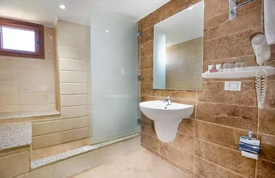 a bathroom with a sink and a mirror at Obelisk Nile Hotel Aswan in Aswan