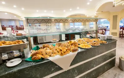 a buffet line with various types of bread and pastries at Obelisk Nile Hotel Aswan in Aswan