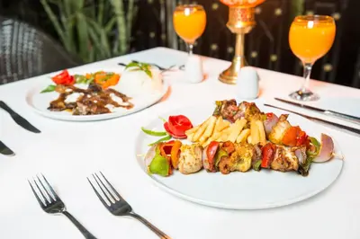 a white table with plates of food on it at Obelisk Nile Hotel Aswan in Aswan