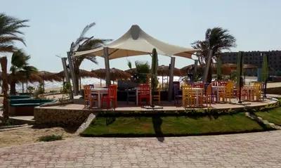a group of tables and chairs under a tent at Royal Beach Serviced Apartments in Hurghada