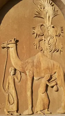 a stone relief of an elephant and a man and a woman at Qasr El Bagawat Hotel in ‘Ezbet Halfa