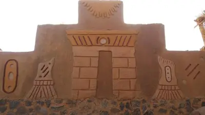 a sand sculpture of a castle with twowindows at Qasr El Bagawat Hotel in ‘Ezbet Halfa