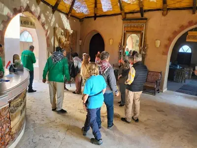 a group of people standing around in a building at Qasr El Bagawat Hotel in ‘Ezbet Halfa
