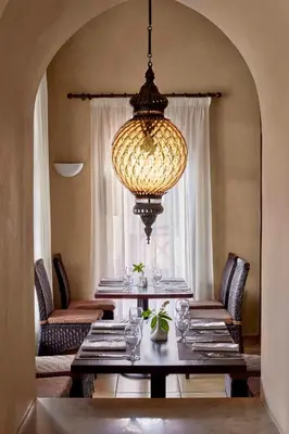a dining room with a table and a chandelier at JAZ Neo Dar El Madina in Coraya Bay