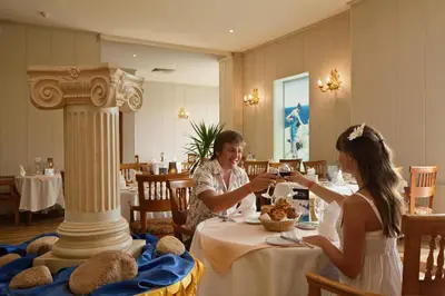 two women sitting at a table in a restaurant at Titanic Beach - Families and Couples only in Hurghada