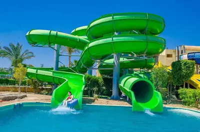 a person riding a water slide at a water park at Titanic Beach - Families and Couples only in Hurghada