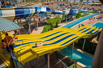 a woman laying on a slide at a water park at Titanic Beach - Families and Couples only in Hurghada