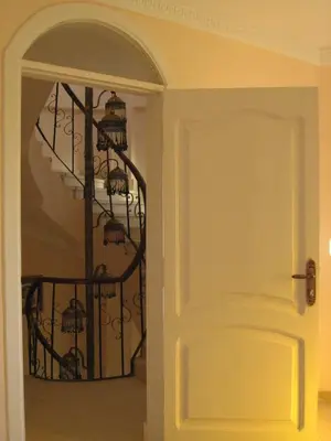a room with a staircase with a spiral stair case at Villa Shahrazad Hurghada in Hurghada