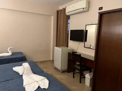 a hotel room with a towel on the bed at Anglo Hotel in Luxor