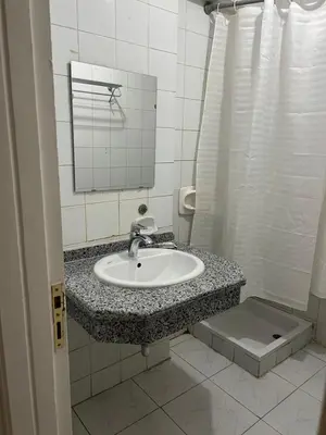 a bathroom with a sink and a mirror at Anglo Hotel in Luxor