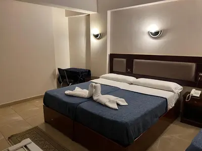 a bedroom with a bed with two towels on it at Anglo Hotel in Luxor