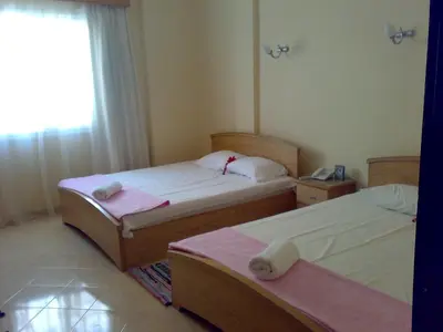 two beds in a hotel room with towels on them at Palm Beach Apartments 302B in Hurghada