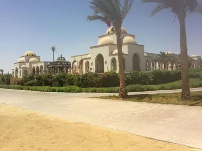 a mosque with palm trees in front of a road at Palm Beach Apartments 302B in Hurghada