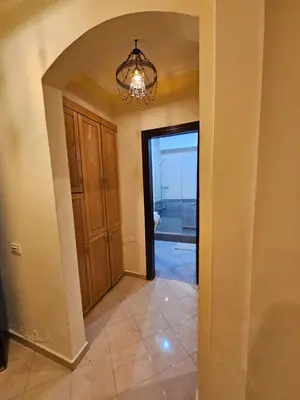 a hallway with a door and a chandelier at Palm Beach Apartments 302B in Hurghada