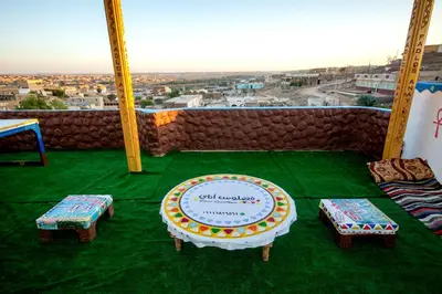 a room with a table and benches and a view at Fadlos Anay Nubian Guesthouse فضلوس أناي in Aswan