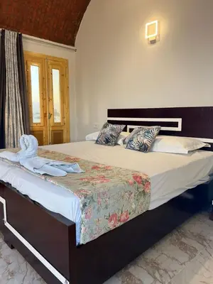 a bedroom with a large bed with towels on it at Full Moon House in Luxor