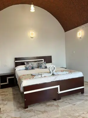 a bedroom with a large bed in a room at Full Moon House in Luxor