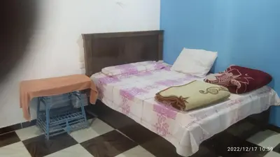 a bed and a table in a room at Al Salam Camp in Luxor