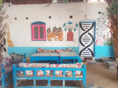 a room with beds and paintings on the wall at Al Salam Camp in Luxor
