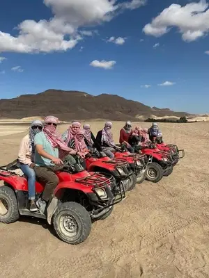 a group of people riding atvs in the desert at Al Salam Camp in Luxor