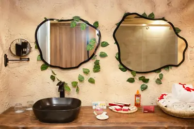 a bathroom sink with a mirror on a wall at Caves Beach Resort Adults Only in Hurghada