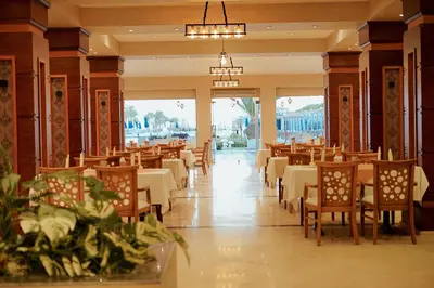 a dining room with tables and chairs in a restaurant at Gravity Hotel & Aqua Park Hurghada Families and Couples Only in Hurghada