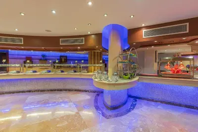 a swimming pool in a hotel lobby with a bar at Gravity Hotel & Aqua Park Hurghada Families and Couples Only in Hurghada