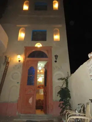 a building with a wooden door with lights above it at Villa Nile House Luxor in Luxor