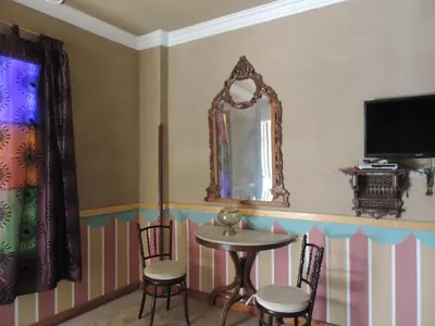 a dining room with a table and chairs and a mirror at Villa Nile House Luxor in Luxor