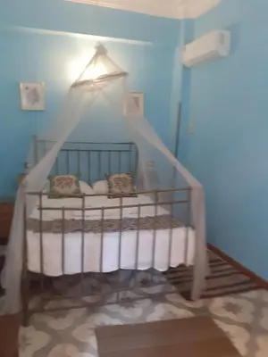 a blue room with a crib with a canopy at Villa Nile House Luxor in Luxor