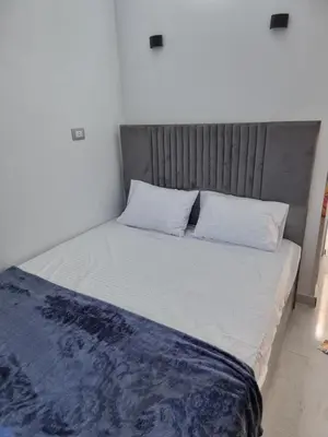 a bed with white sheets and pillows in a room at Baba Dool in Aswan