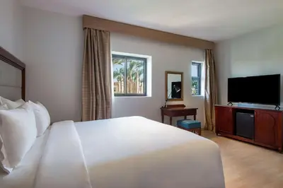a hotel room with a bed and a flat screen tv at Marina Resort Port Ghalib, a member of Radisson Individuals in Port Ghalib