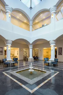 a lobby with a fountain in the middle of a room at Marina Resort Port Ghalib, a member of Radisson Individuals in Port Ghalib