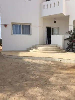 a white building with stairs and a building at Twin Lagoon Apartment at White Villas El Gouna in Hurghada