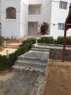 a building with stairs in front of a building at Twin Lagoon Apartment at White Villas El Gouna in Hurghada