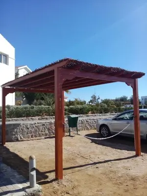 a car is chained up to a wooden structure at Twin Lagoon Apartment at White Villas El Gouna in Hurghada