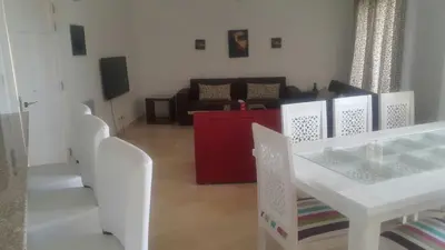 a living room with a white table and chairs at Twin Lagoon Apartment at White Villas El Gouna in Hurghada
