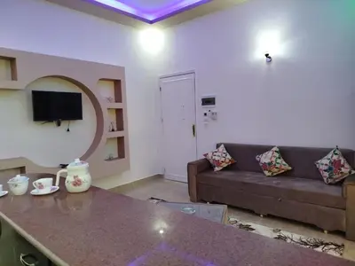 a living room with a couch and a table at Luxor Star Apartments in Luxor