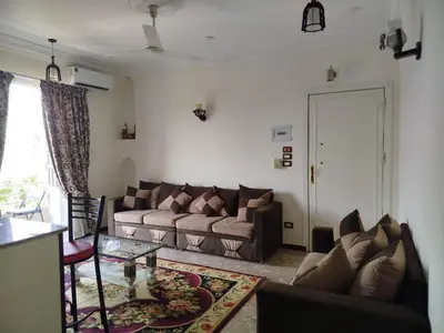a living room with a couch and a table at Luxor Star Apartments in Luxor
