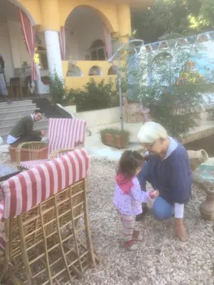 a woman and a little girl playing with something at The Mango Guest House in Aswan