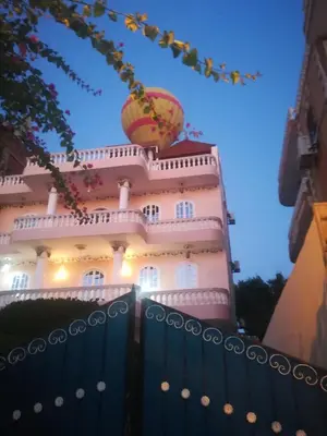 a building with a fence in front of it at Luxor palace Apartments in Luxor