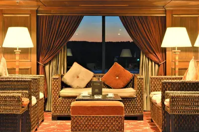 a living room with two chairs and a table with a laptop at JAZ Crown Jubilee Nile Cruise - Every Thursday from Luxor for 07 & 04 Nights - Every MondayFrom Aswan for 03 Nights in Luxor
