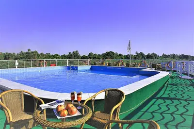a pool on a cruise ship with a table and chairs at JAZ Crown Jubilee Nile Cruise - Every Thursday from Luxor for 07 & 04 Nights - Every MondayFrom Aswan for 03 Nights in Luxor